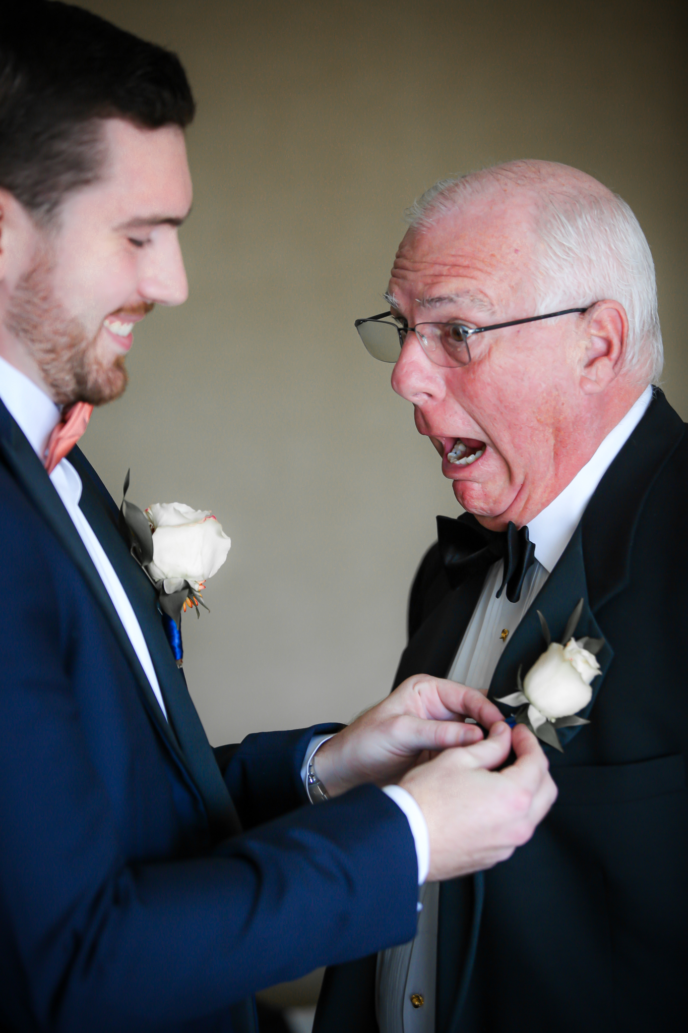 A groom pins a corsage on a family member at the Grove Park Inn Hotel. 