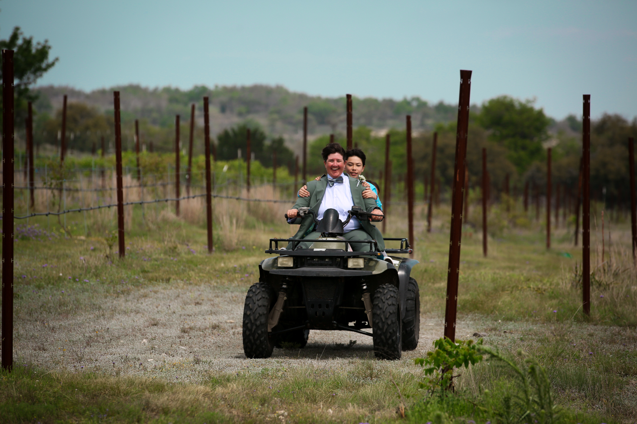 One of the brides arrives via 4 x 4 at a wedding in Texas. 